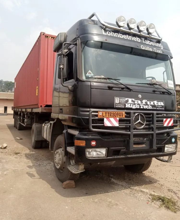 Mercedes Actros tractor pulling a 40-foot shipping container on a skeletal trailer in Douala, Cameroon