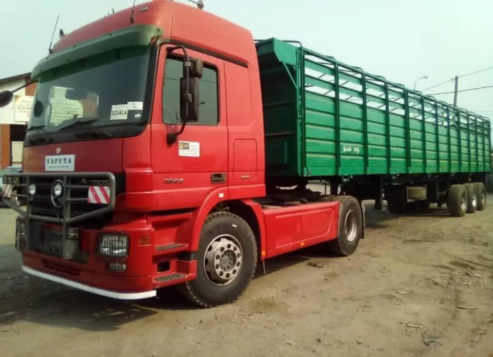 Red Mercedes Actros with a high-sided cargo trailer used on Central African corridors