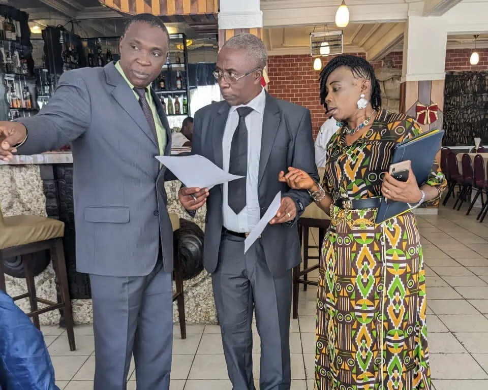 Three Transconnecta team members reviewing shipment documents together