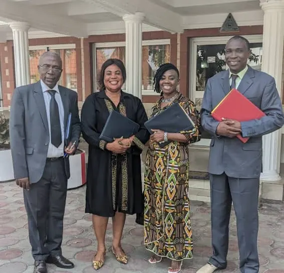 Four Transconnecta staff members holding client files outside a meeting venue